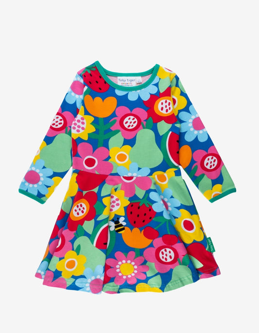Colorful children's dress with floral and fruit pattern on a white background