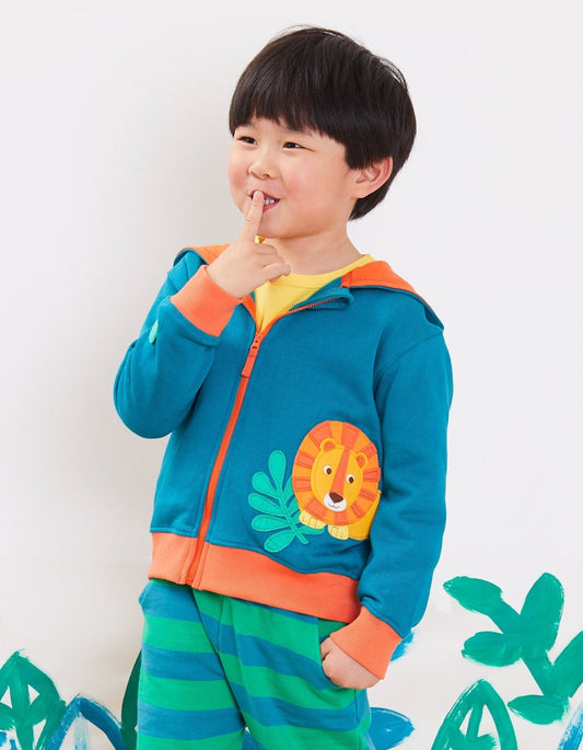 Child wearing a colorful outfit with a lion design hoodie on a white background.