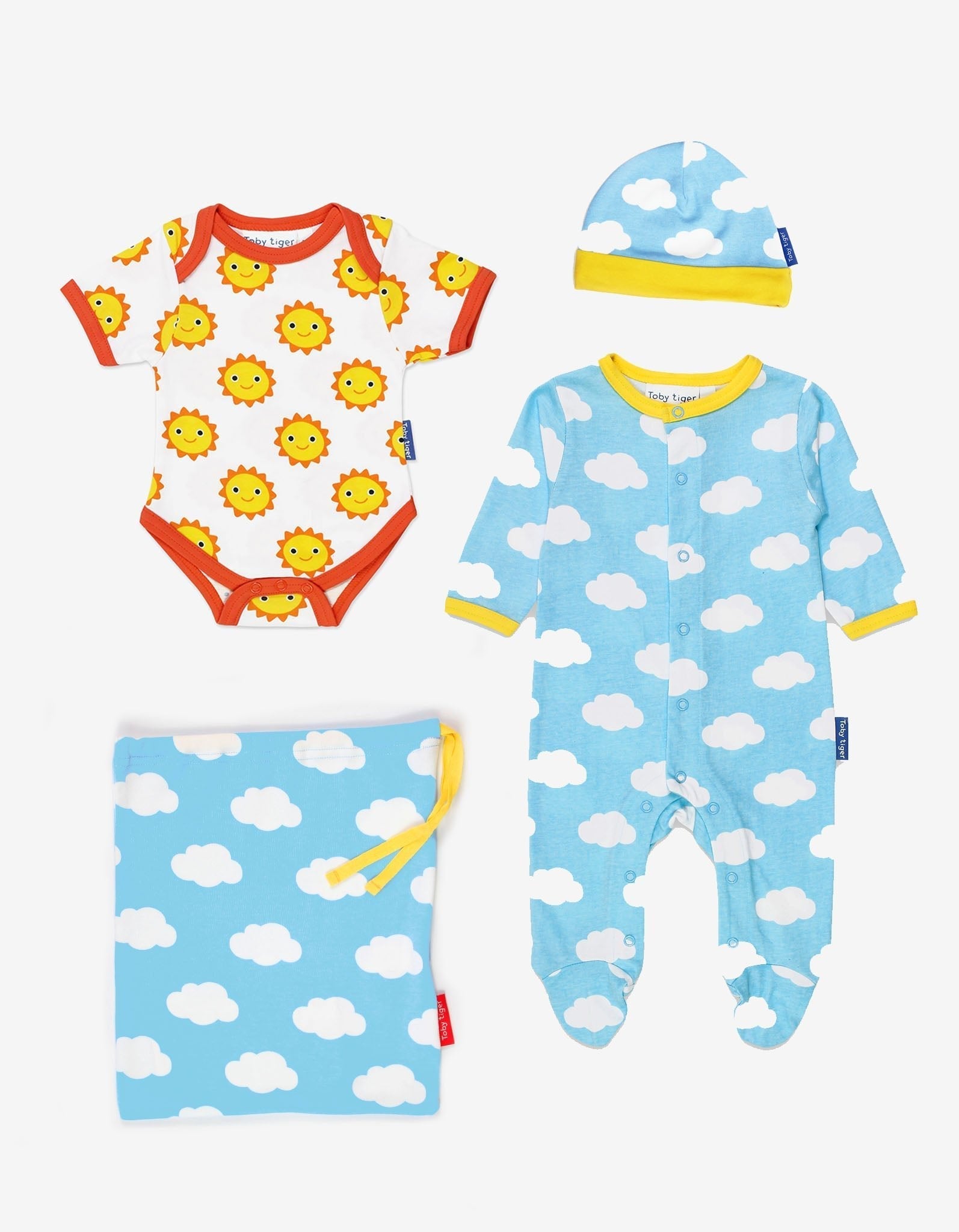 Baby gift set with onesie, hat, and blanket featuring sun and cloud patterns on a white background.