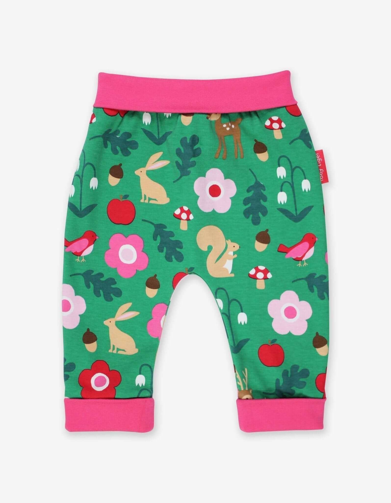 Baby yoga pants with a forest animal pattern on a green background