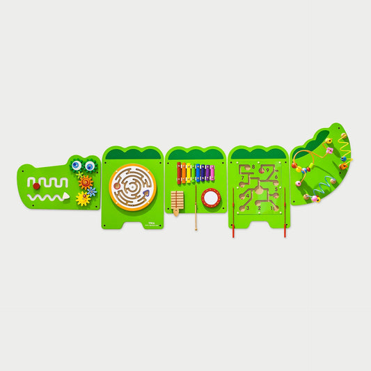 Green crocodile-shaped educational toy with various interactive elements on a light gray background