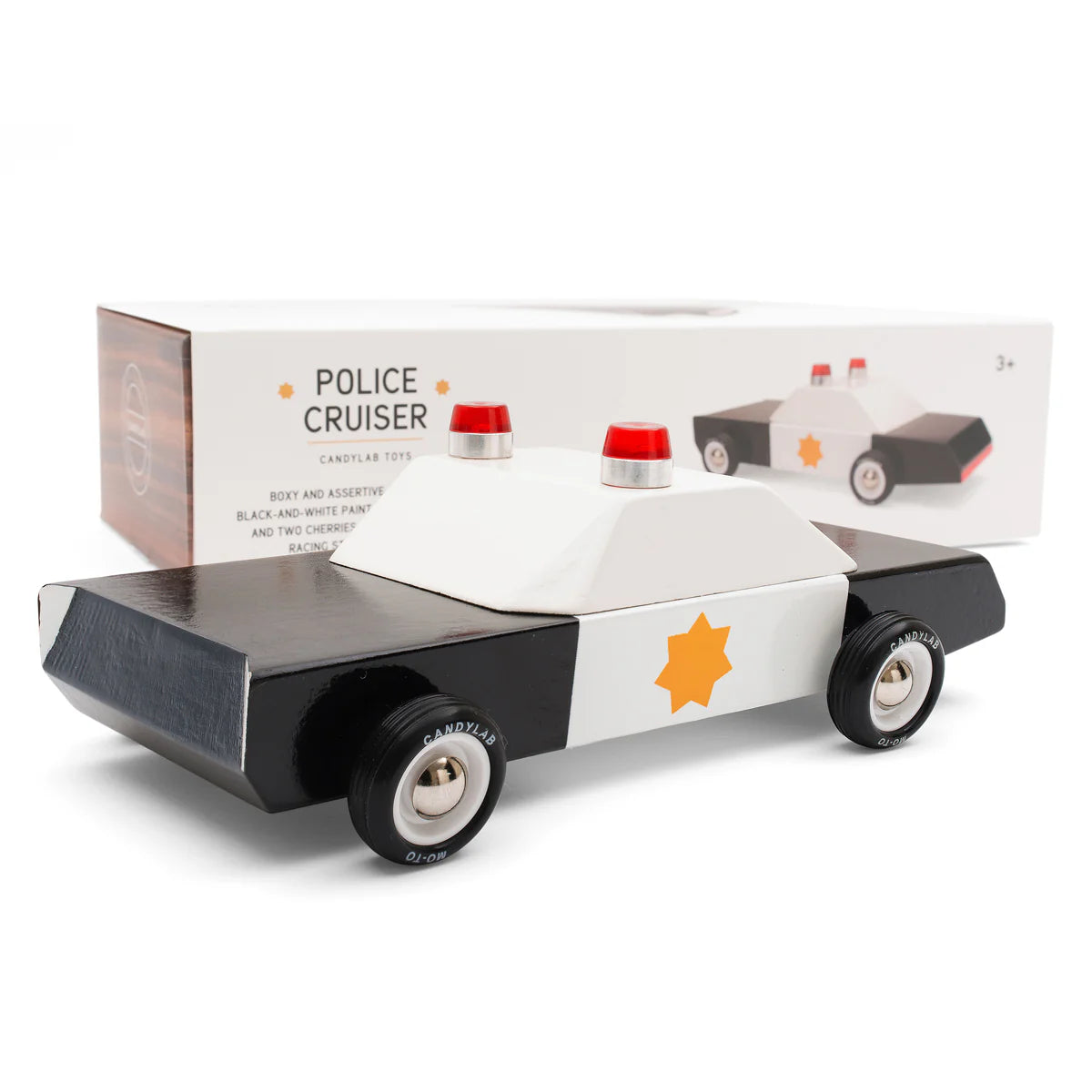 Toy police cruiser with box on a white background