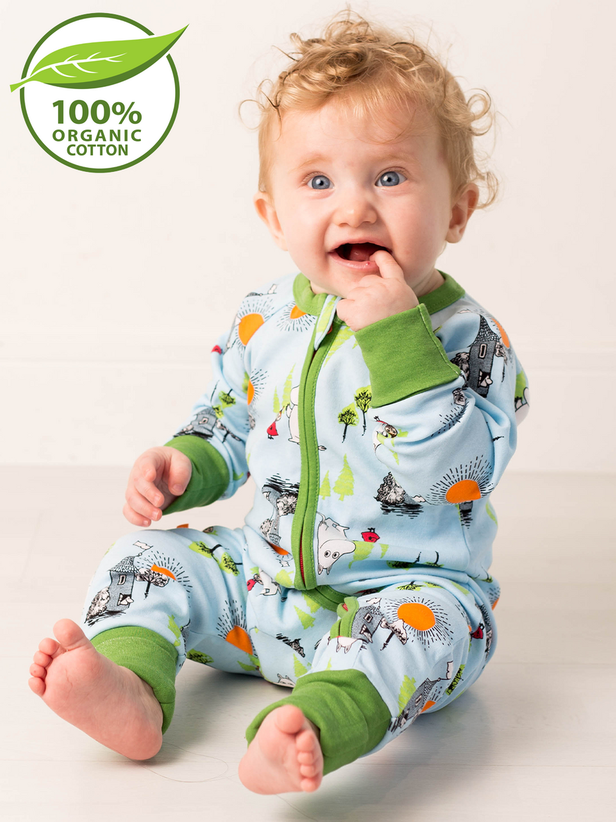 Baby wearing a 100% organic cotton onesie with moomin print on a light background