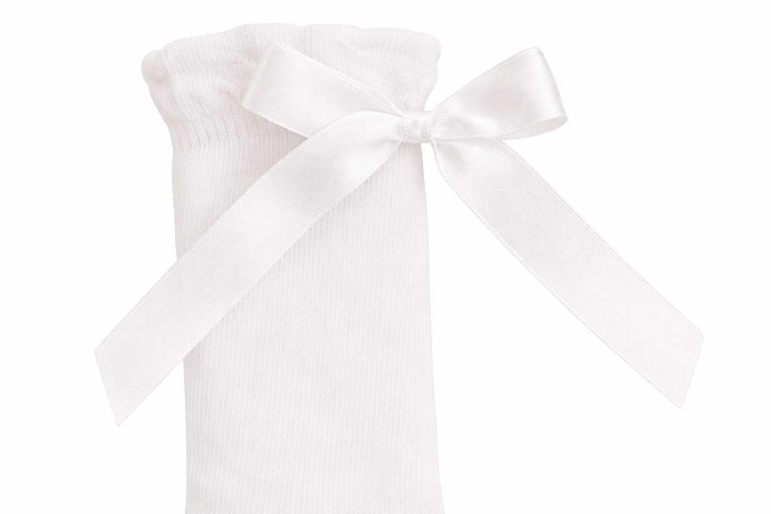 Close-up of ribbon detail on knee high cotton socks for children