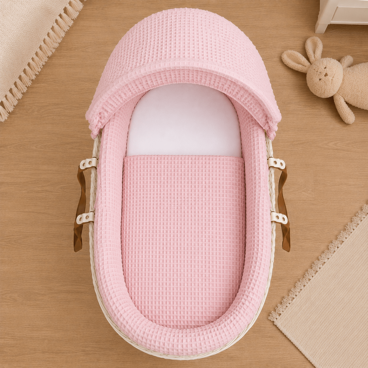 Moses basket with pink waffle bedding