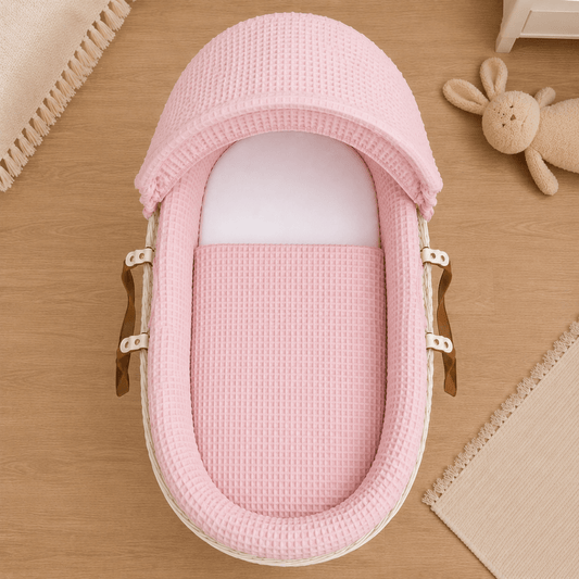 Moses basket with pink waffle bedding
